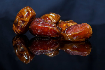 Kurma or dates fruits isolated on black background, Popular During Ramadhan or Fasting Month. Ramadhan food. Selective focus