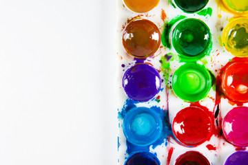 A set of children's paints in circular forms close-up. Copy space for text