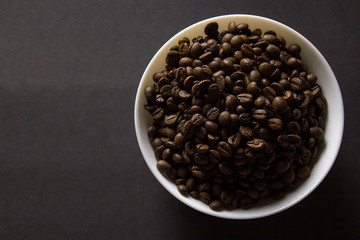 plate with coffee on black background with copy space