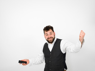 young man with black beard is posing and looking at his smartphone in front of white background with different emotions