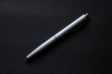 white pen on black background with copy space