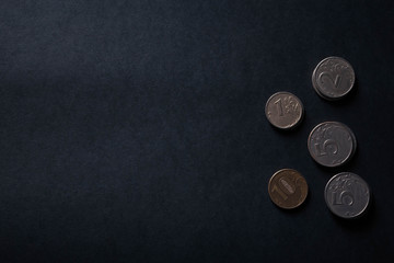 coins on black background with copy space