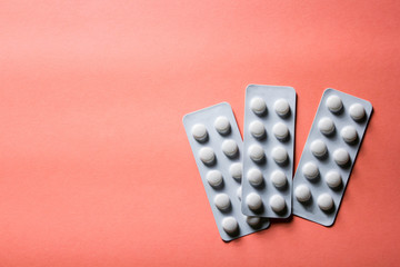 pills in blister on pink background with copyspace