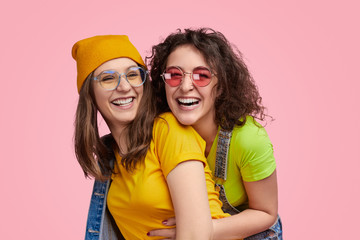 Laughing lesbian couple looking at camera