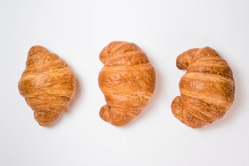 Breakfast three croissants on a white background