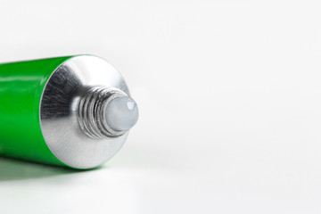 open tube of ointment cream on a white background with copy space