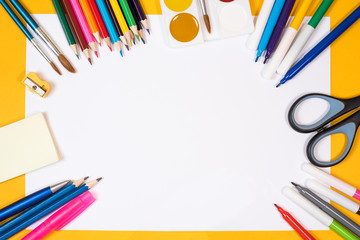 Fototapeta premium Back to school. Children's creativity. Colored pencils, felt-tip pens, brushes and paints, scissors on a yellow background