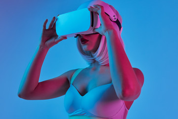Futuristic female exploring virtual reality