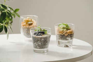 Fruits yogurt parfait with granola and chia seeds for healthy breakfast on wooden table