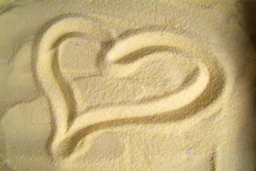 Fototapeta na wymiar Heart drawn on sand, yellow