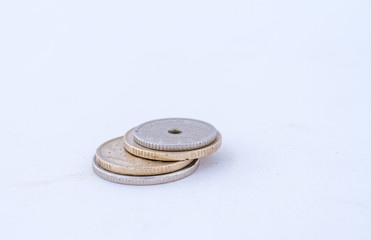 A small stack of coins isolated on a white background image with copy space in landscape format