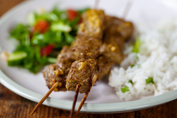 Lamb kebab with rice and salad