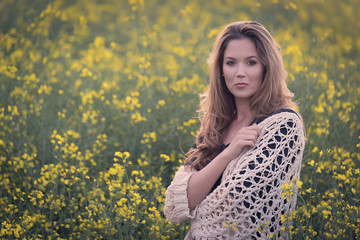 Beautiful woman in rapeseed field