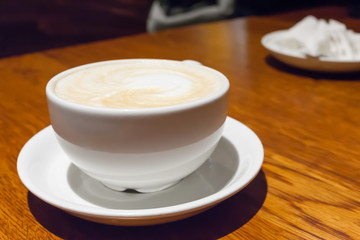 mug from a cappuccino on a wooden table