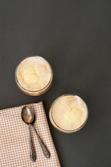 Fototapeta premium Coffee cold drink with ice cream and espresso. Affogato deliciouse summer refreshing drink in glass. Top view, copy space.