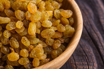 golden raisins on a wooden rustic background