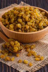 golden raisins on a wooden rustic background