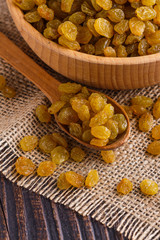 golden raisins on a wooden rustic background