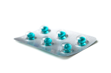 closeup of blue pills on white background