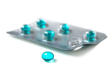 closeup of blue pills on white background