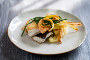Sea bass fillet with parsnip crisp and samphire 