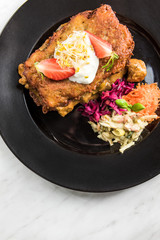 Potato pancake with meat and salad, restaurant dish