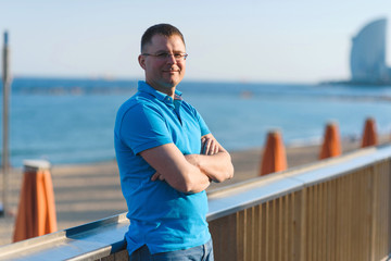 man at beach fence at sunset