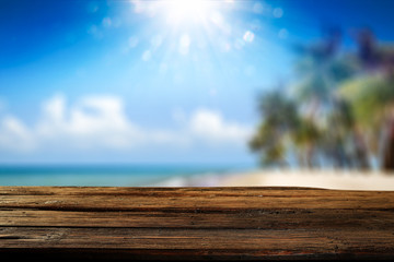 Desk of free space and summer background of beach with palms and summer sea 