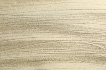 Clear sea sand as background, space for text and closeup. Summer vacation background