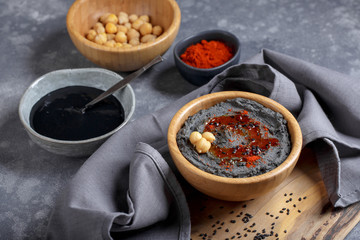 Black hummus with black sesame tahini.  Traditional middle eastern appetizer. Trendy food, healthy vegan food.