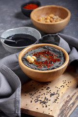 Black hummus with black sesame tahini.  Traditional middle eastern appetizer. Trendy food, healthy vegan food.