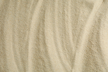 Fototapeta na wymiar Clear sea sand as background, space for text and closeup. Summer vacation background