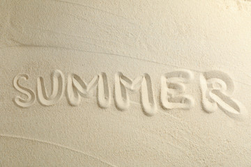 Clear sea sand with inscription summer, space for text and top view. Summer vacation background