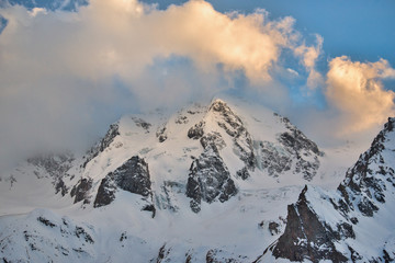 Fototapeta na wymiar mountain slopes covered with snow with glaciers in the evening at sunset. Kabardino-Balkaria, Russia