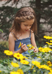 portrait of happy beautiful girl in flowerbed