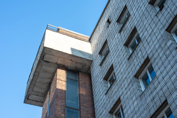  Brick high house with windows. Blue sky. Soviet architecture