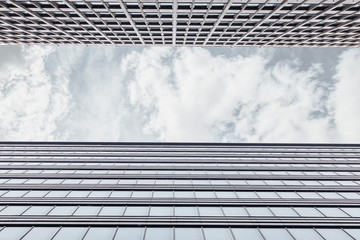 Framing With The Facade Of The Office Building Shot From The Bottom Up With A Horizontal Strip Of Gray Sky With Clouds. Business Centre On A Cloudy Day