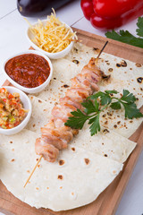 Cooked chicken kebab on a wooden board