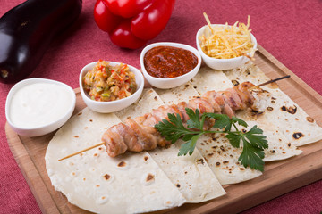 Cooked chicken kebab on a wooden board