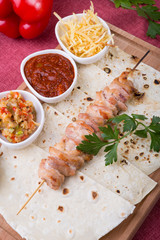 Cooked chicken kebab on a wooden board