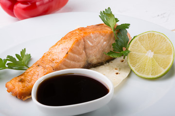 Prepared salmon steak served on a plate