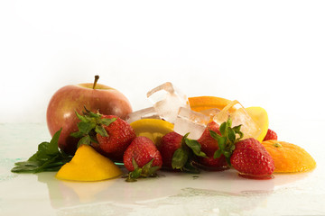 Wet fresh cold strawberrys apple and citrus on white