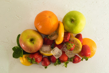 Top view of various fresh fruits with ice