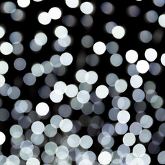 Abstract bokeh of white city lights on black background. defocused and blurred many round light