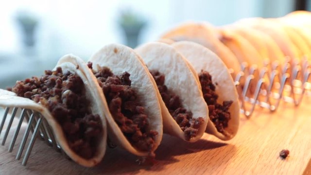 Close up of soft beef tacos on rack