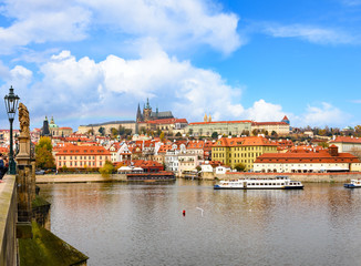 river,europe,old,town,architecture,city,travel,sky,summer,cityscape,tower,tourist,tourism,castle,history,medieval,blue,day,prague,vltava river,looking at view,scenics - nature,city life,urban skyline,