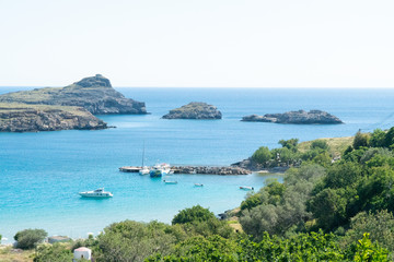 Lindos ,Rhodes/Greece May 2 2019 : the most historic village of the island and the view of the blue sea the beach and some white houses  from the centre square