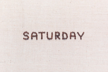 The word Saturday written with coffee beans , aligned in the center.