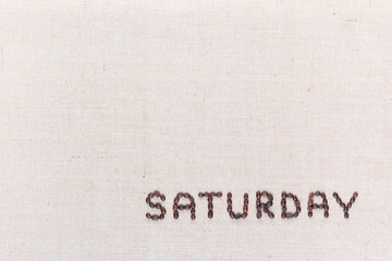 The word Saturday written with coffee beans , aligned at the bottom right.