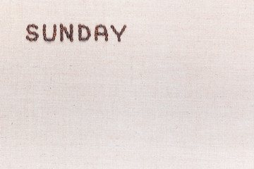 The word Sunday written with coffee beans , aligned at the top left.